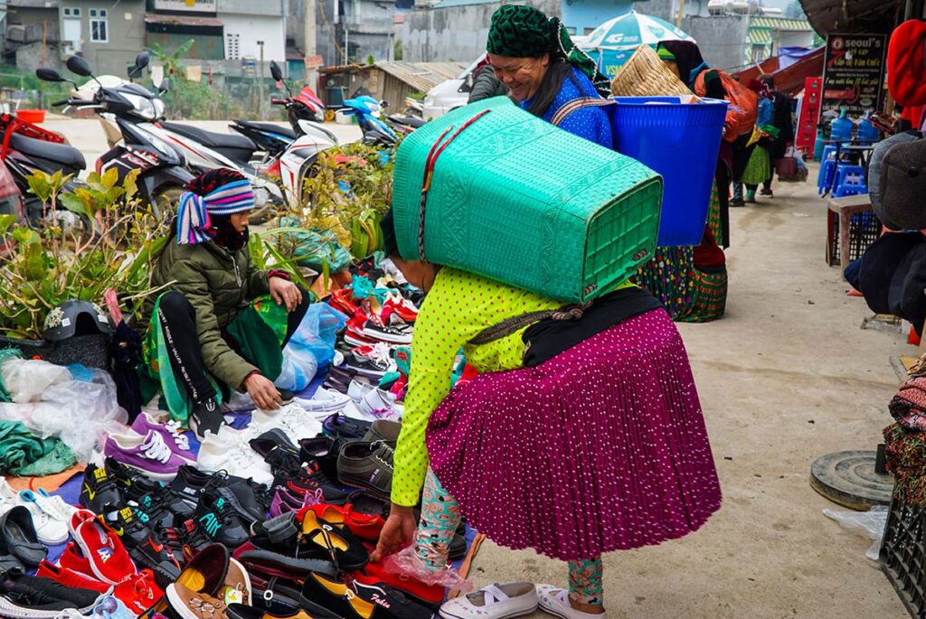 ethnic minority people shopping for clothes at Dong Van Market