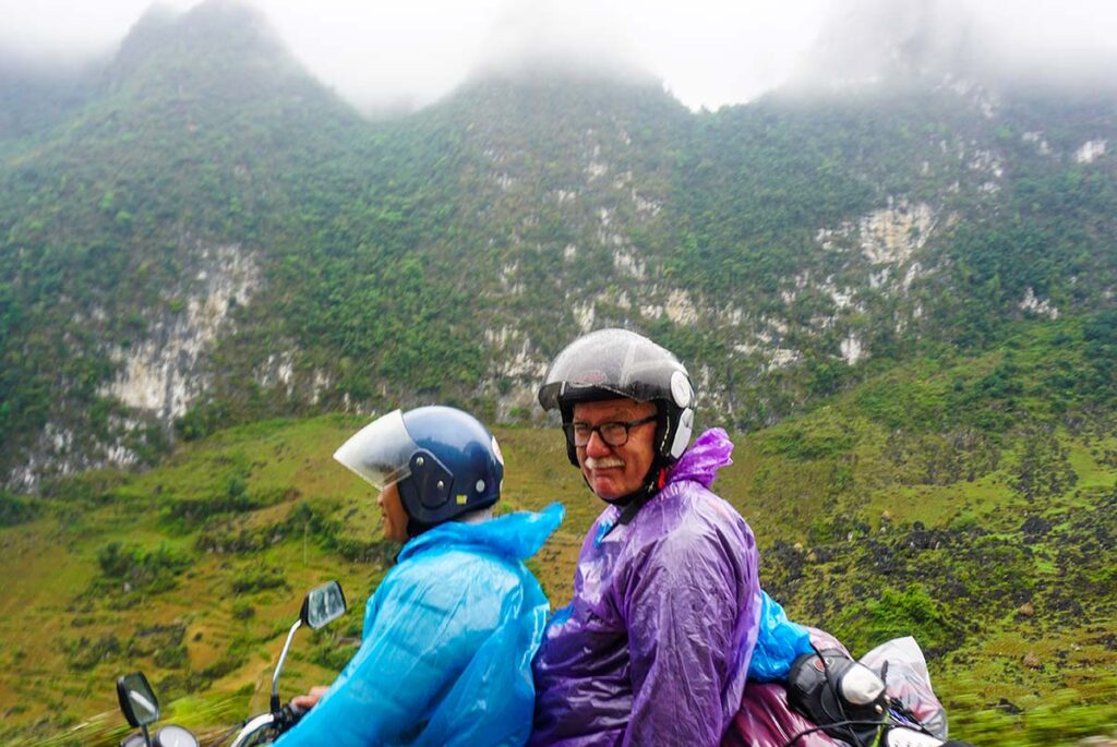 Ha Giang Loop by easy rider with foreign travelers on the back of a motorbike with local guide