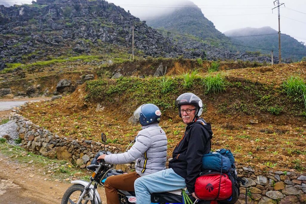 Ha Giang Loop by easy rider with foreign travelers on the back of a motorbike with local guide