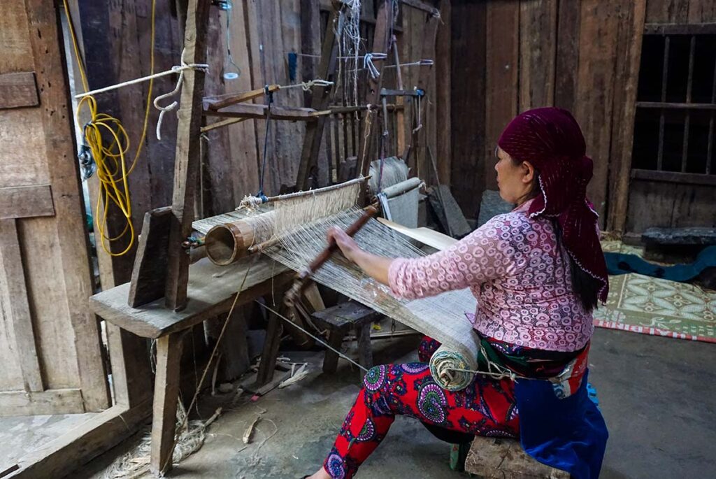 ethnic Hmong woman weaving linen in Lung Tam Village in Ha Giang
