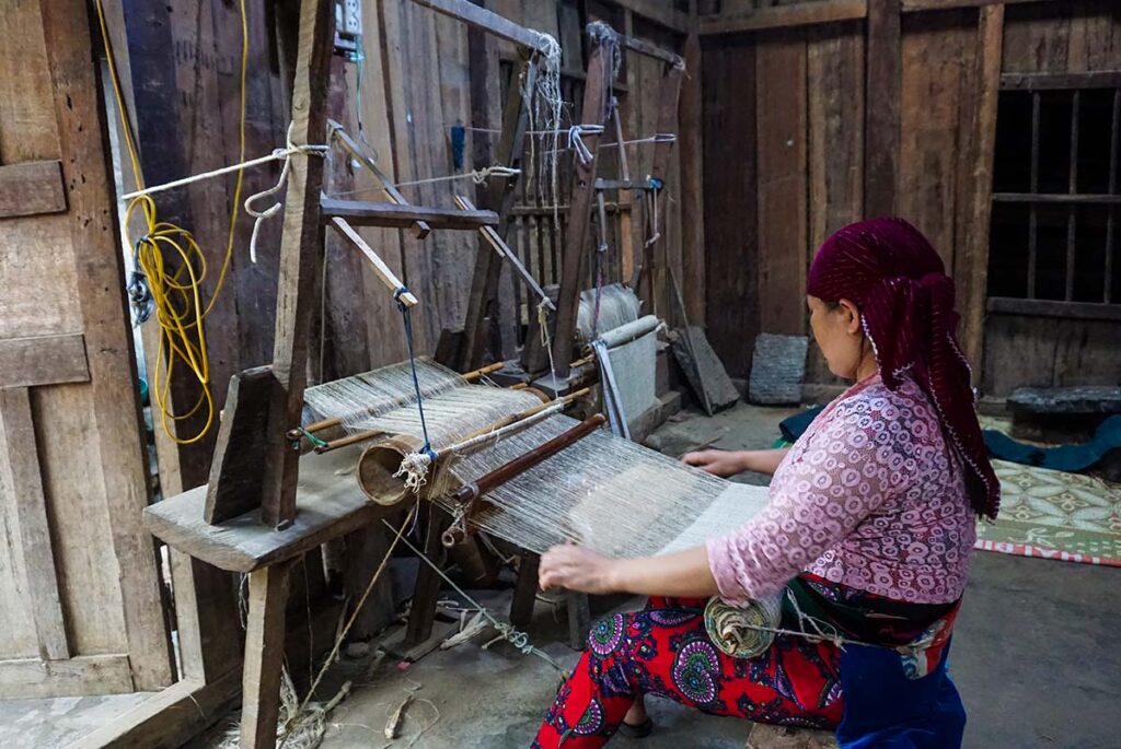 ethnic Hmong woman weaving linen in Lung Tam Village in Ha Giang
